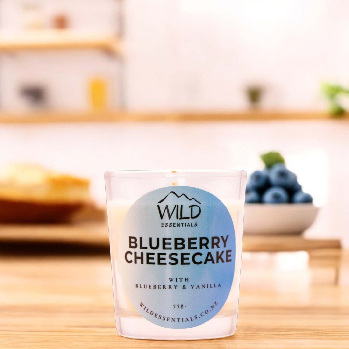Photograph of the Blueberry Cheesecake Mini Candle from Wild Essentials, taken in a modern kitchen.