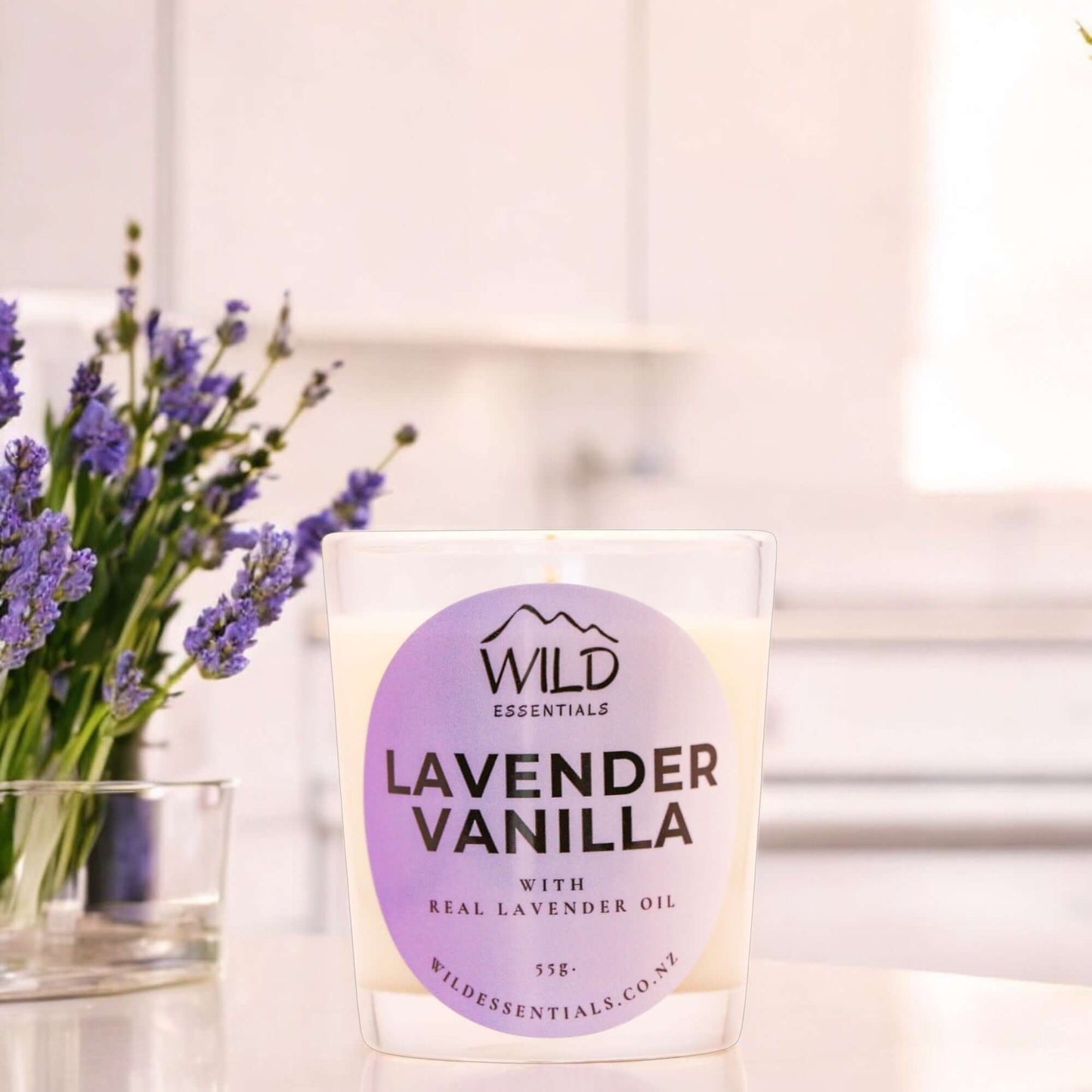 Photograph of the Lavender Vanilla Mini Candle from Wild Essentials, taken in a modern kitchen.