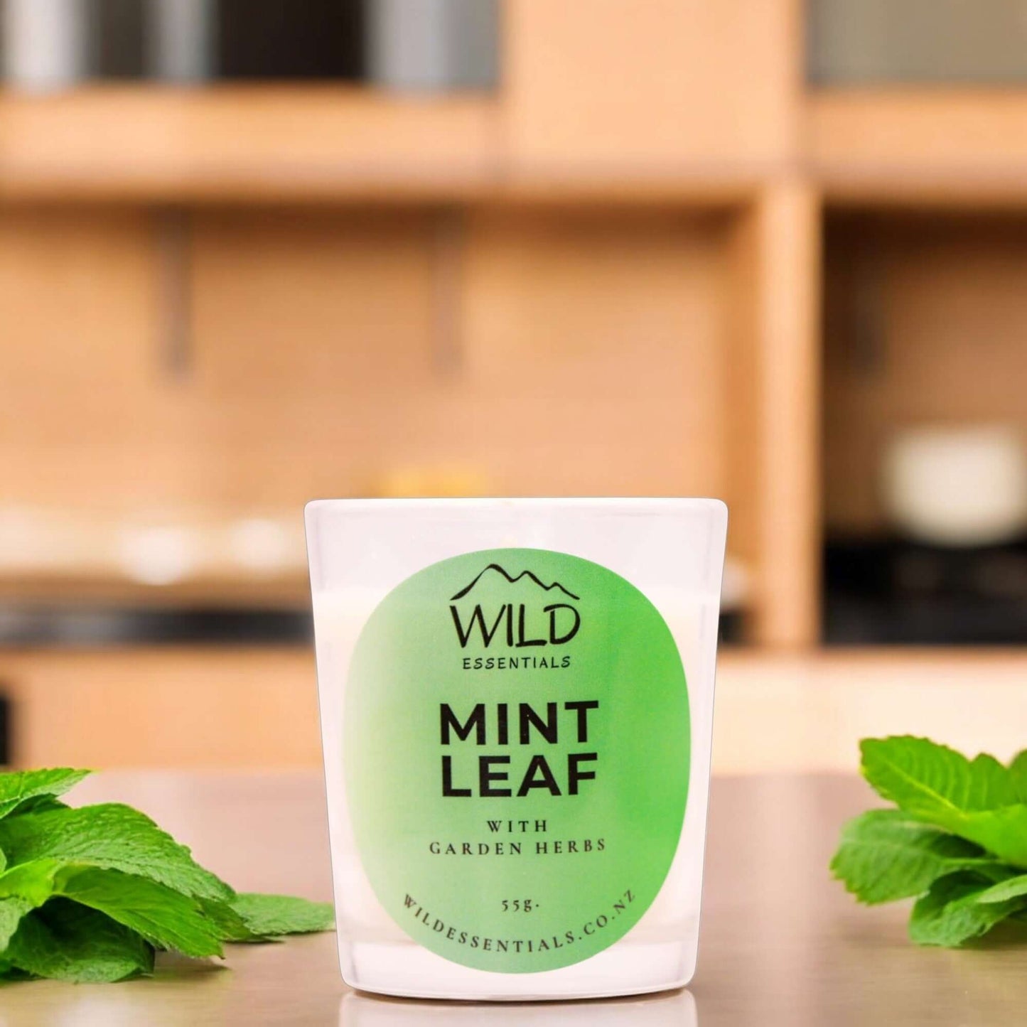 Photograph of the Mint Leaf Mini Candle from Wild Essentials, taken in a modern kitchen.