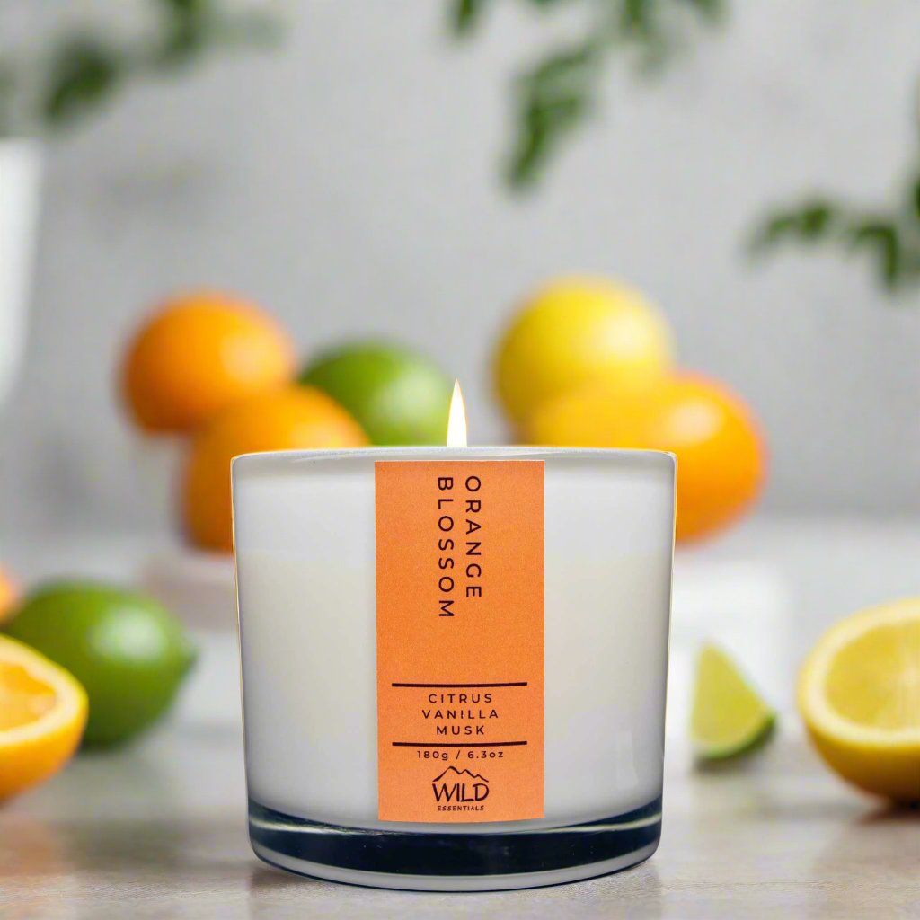 Photograph of the Luxurious Orange Blossom Aromatherapy Candle by Wild Essentials with scents of Citrus, Vanilla, and Musk with background.