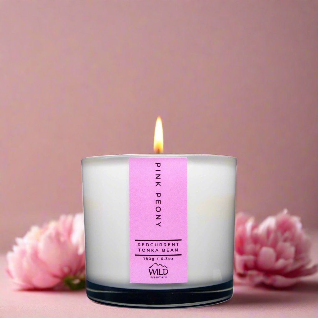 Photograph of the Luxurious Pink Peony Aromatherapy Candle by Wild Essentials with scents of Redcurrant and Tonka Bean with background.