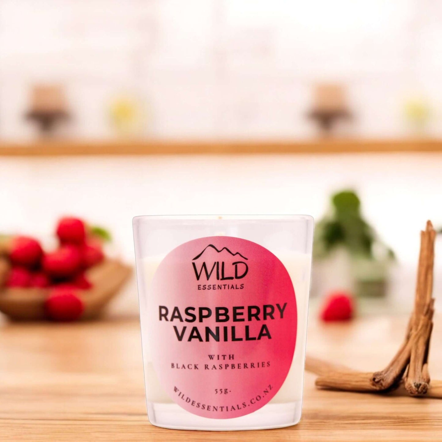Photograph of the Raspberry Vanilla Mini Candle from Wild Essentials, taken in a modern kitchen.