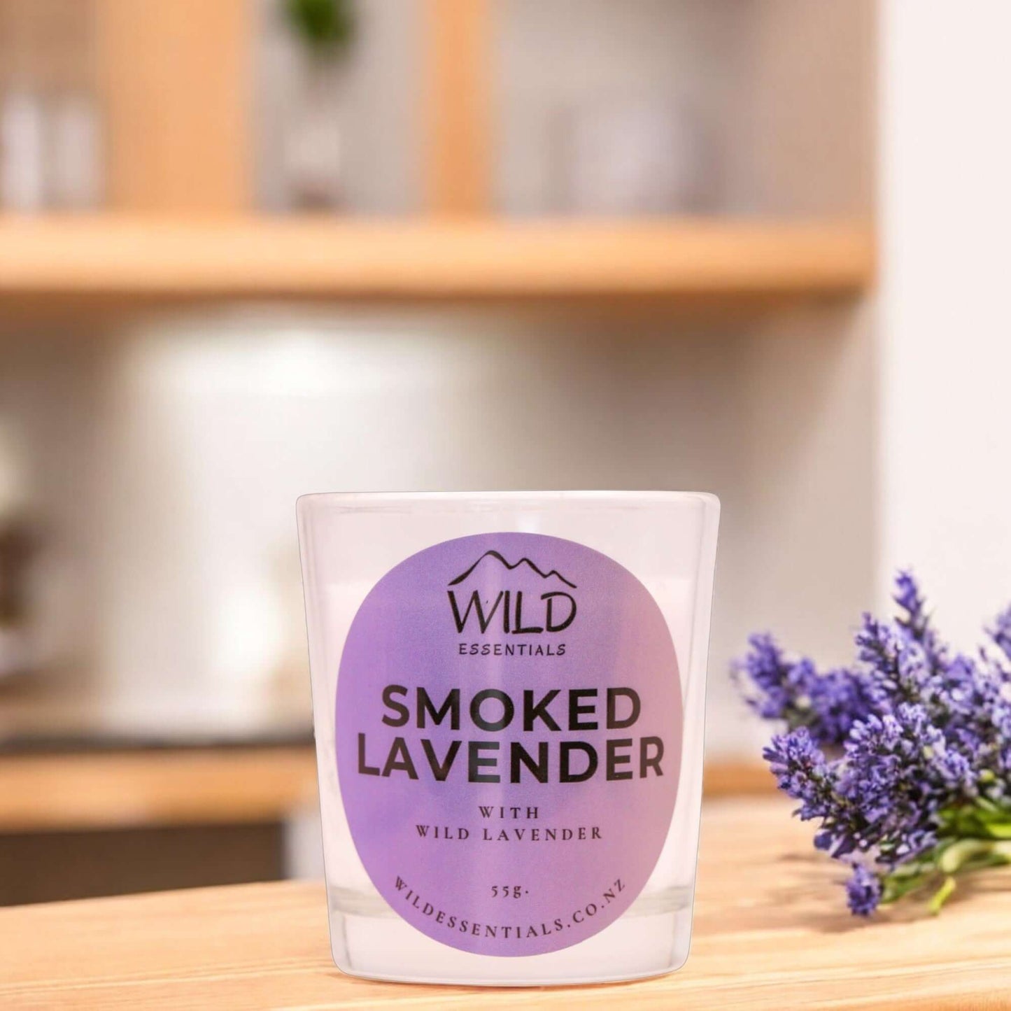 Photograph of the Smoked Lavender Mini Candle from Wild Essentials, taken in a modern kitchen.