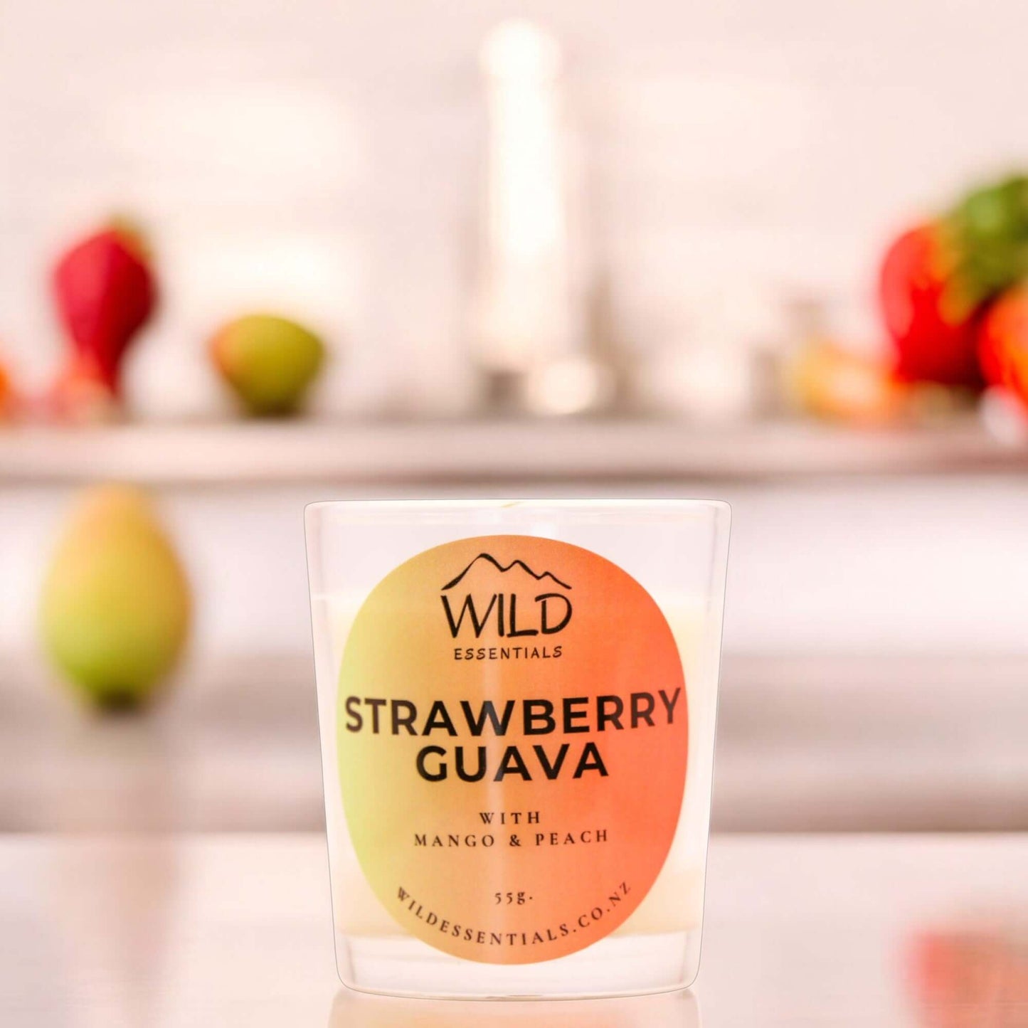 Photograph of theStrawberry Guava Mini Candle from Wild Essentials, taken in a modern kitchen.