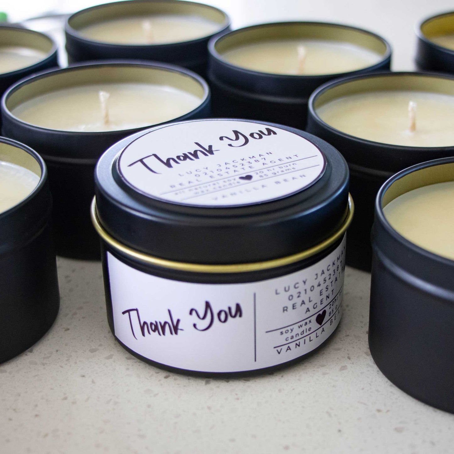 Photo of a Vanilla Bean scented Thank You Candle favour from Wild Essentials, surrounded by other candles.