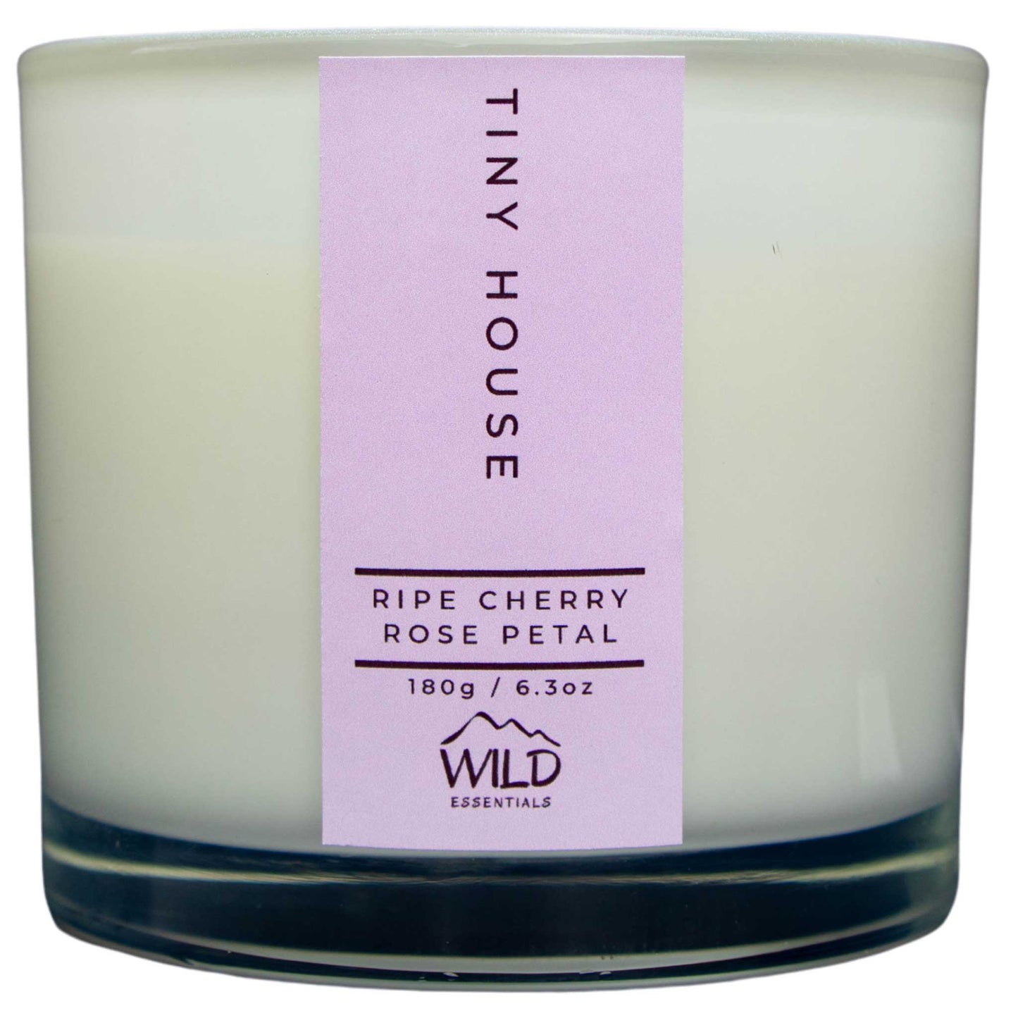 Photograph of the Luxurious Tiny House Aromatherapy Candle by Wild Essentials with scents of Ripe Cherry and Rose Petal.