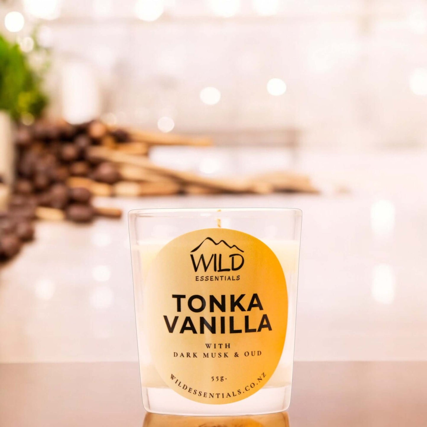 Photograph of the Tonka Vanilla Mini Candle from Wild Essentials, taken in a modern kitchen.