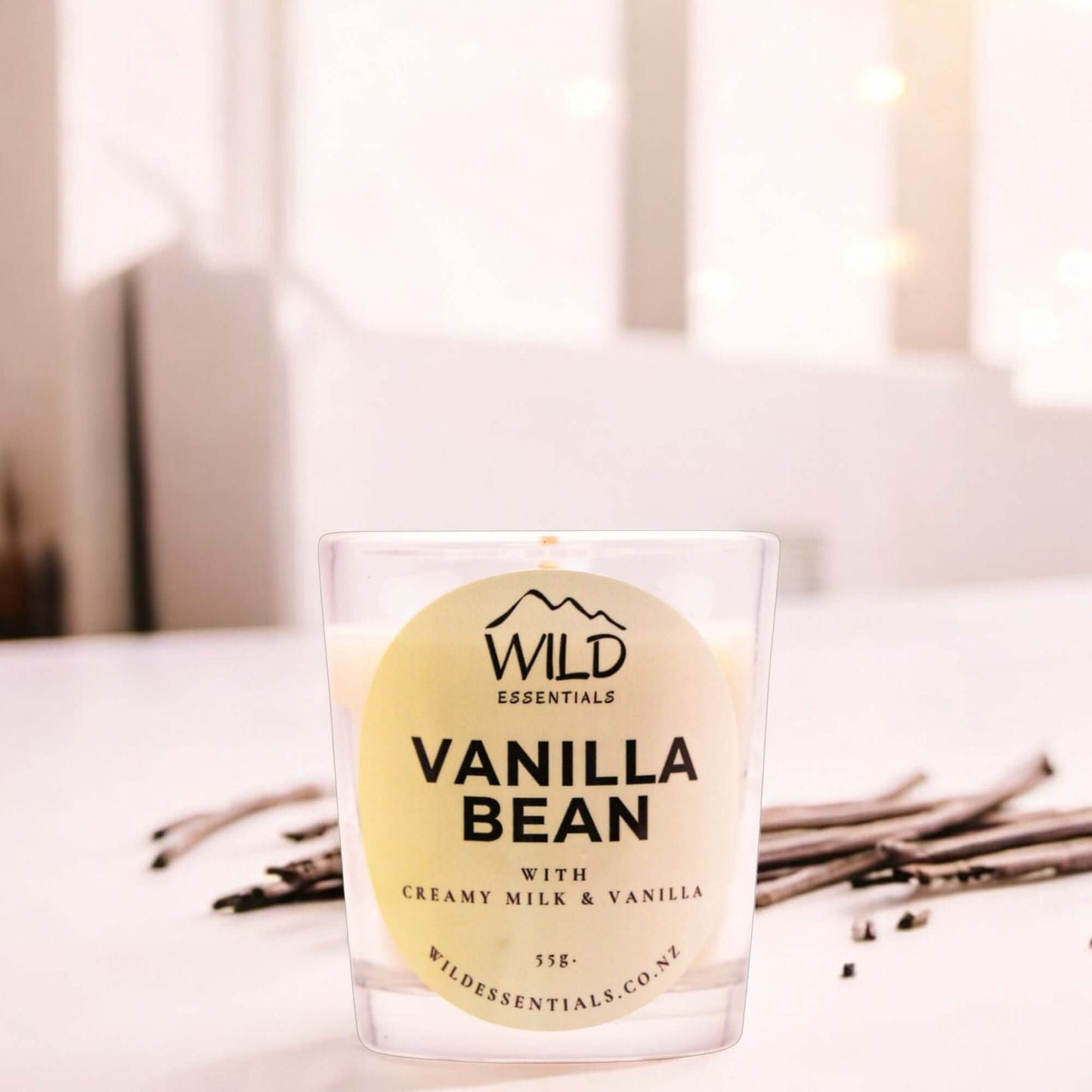 Photograph of the Vanilla Bean Mini Candle from Wild Essentials, taken in a modern kitchen.