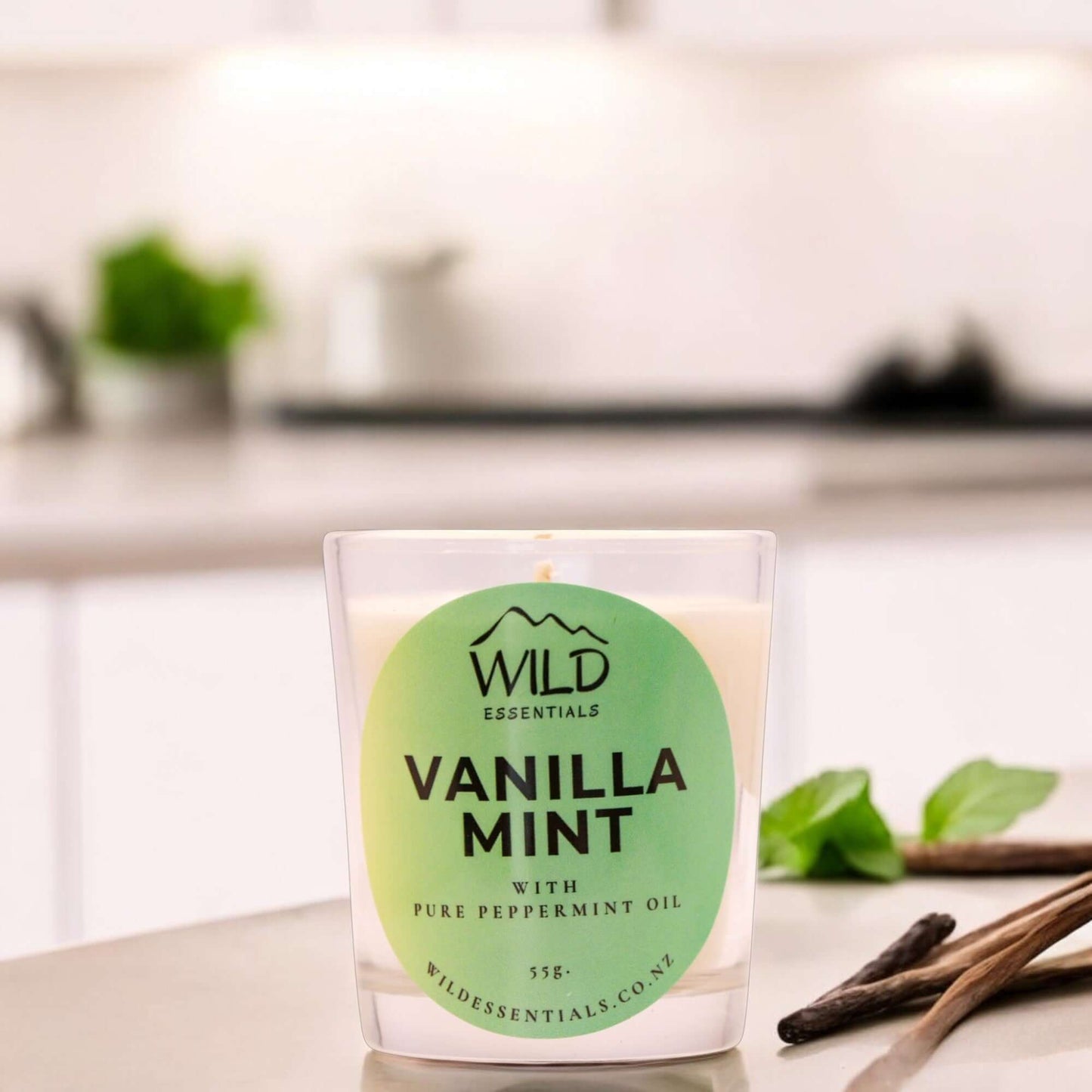 Photograph of the Vanilla Mint Mini Candle from Wild Essentials, taken in a modern kitchen.