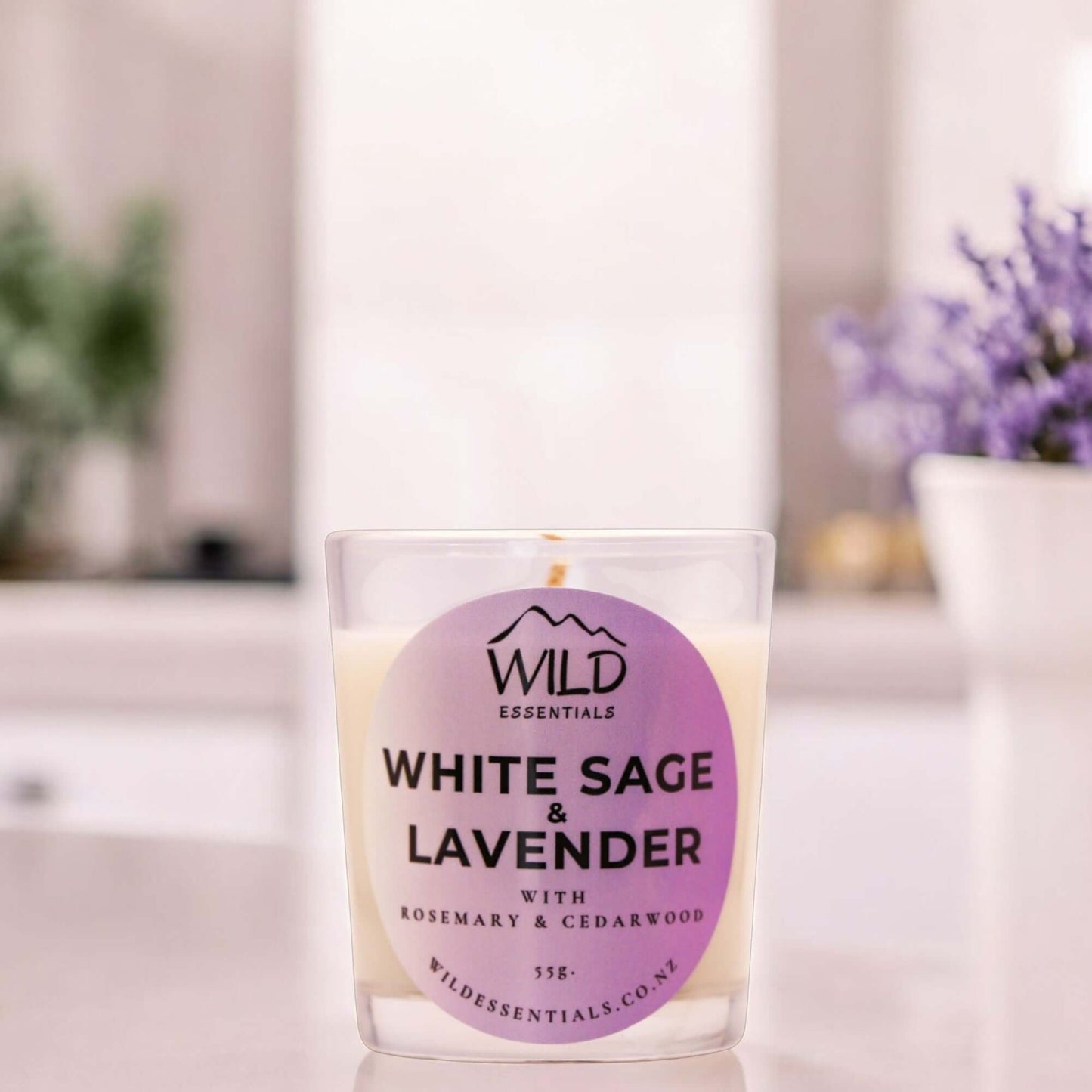 Photograph of the White Sage & Lavender Mini Candle from Wild Essentials, taken in a modern kitchen.
