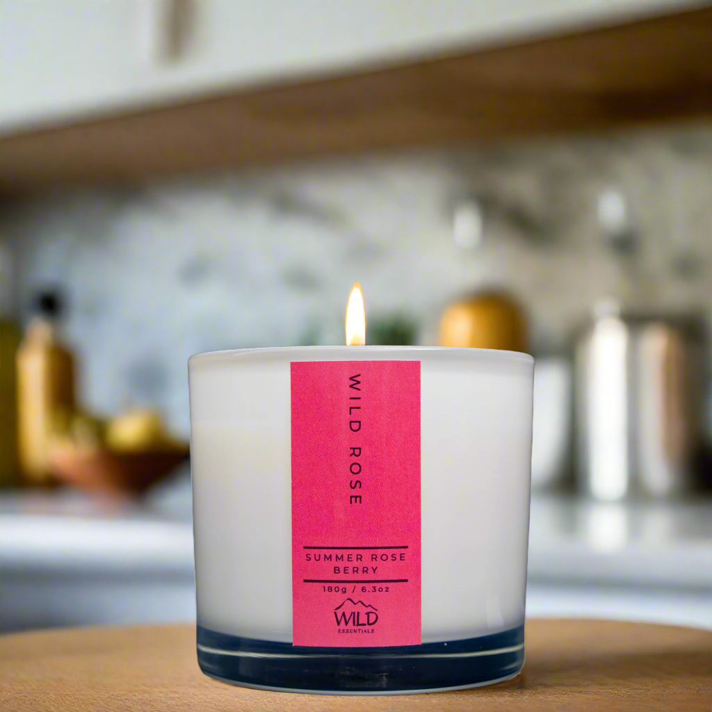 Photograph of the Luxurious Wild Rose Aromatherapy Candle by Wild Essentials with scents of Summer Rose and Berry with kitchen background.