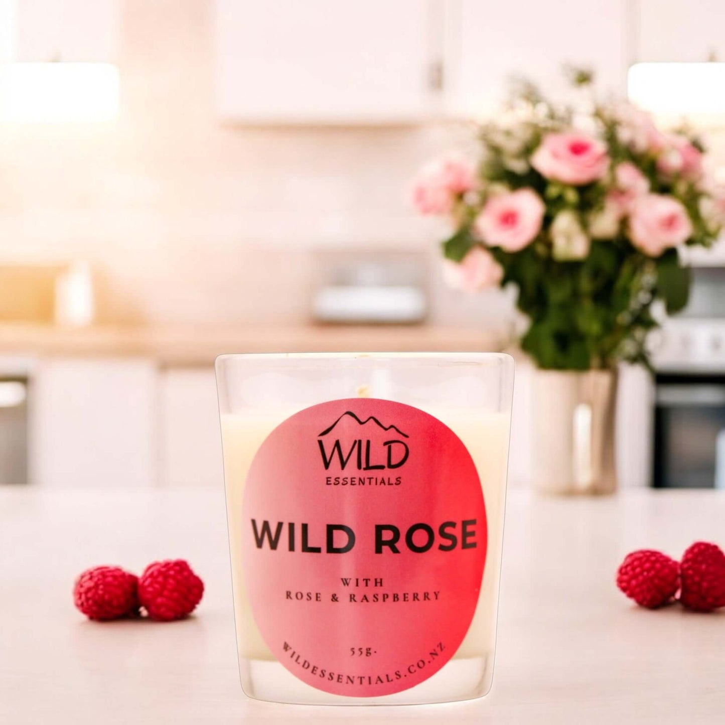 Photograph of the Wild Rose Mini Candle from Wild Essentials, taken in a modern kitchen.